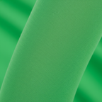 Extreme macro close-up of bright green opaque nylon elf tights fabric showing smooth stretch texture