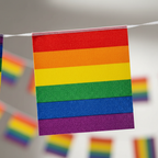 Extreme macro close-up of a single rectangular Rainbow Gay Pride Bunting flag showing fabric texture and rainbow stripe print quality
