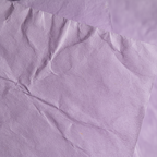 Extreme macro close-up of soft lilac tissue paper texture and delicate fibres