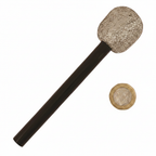 Silver glitter microphone fancy dress prop beside a pound coin showing size scale, flat lay on white background