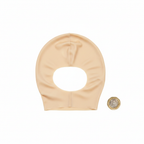 Latex bald cap for adults flat lay on white background beside £1 coin for size reference, overhead lighting