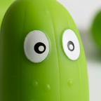 Extreme macro close-up of the Stretchy Squishy Crazy Cucumber showing googly eyes and lime green rubbery texture