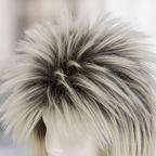 Extreme macro close-up of 80s rockstar wig showing dark spiked crown transitioning to platinum blonde fibres