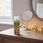Party Success Silver Glitter Hair Spray 125ml styled on dressing table with mirror, pearl earrings and fairy lights, natural window light