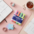 Flat lay of chunky highlighter pens pack of 4 with bullet journal, washi tape and sticky notes on a pastel pink surface