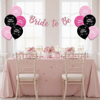 Hen party table decorated with pink and black latex balloons, prosecco glasses and confetti