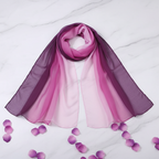 Lightweight gradient purple chiffon neck scarf elegantly draped on marble surface with purple flower petals