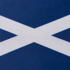 Extreme macro close-up of Scotland flag polyester fabric showing vivid royal blue colour and crisp white saltire print edge detail