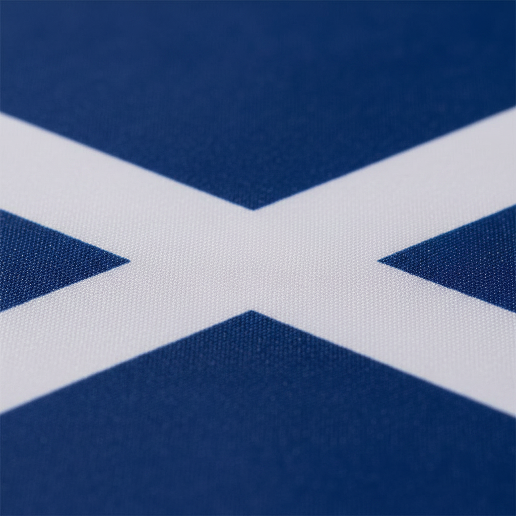 Extreme macro close-up of Scotland flag polyester fabric showing vivid royal blue colour and crisp white saltire print edge detail