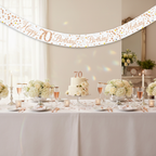 Elegant 70th birthday party table setup with Sparkling Fizz banner and rose gold decorations