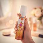 Woman holding Insette Ladies Body Spray Musk 75ml in warm golden hour light, feminine confidence lifestyle shot