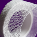 Extreme macro close-up of hemming web tape mesh texture showing fine fusible bonding material quality