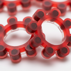 Extreme macro close-up of red Sohni-Wicke cap gun rings showing paper cap dots and translucent plastic ring detail