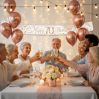 Family and friends celebrating 70th birthday party with Sparkling Fizz rose gold banner displayed on wall
