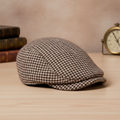 Faux tweed flat cap with brown and beige houndstooth pattern on elegant vintage background