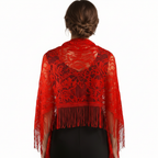 Close-up detail of red lace floral pattern and tassel fringe on evening pashmina shawl