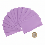 10 sheets of purple tissue paper fanned out beside a £1 coin showing scale, overhead flat lay