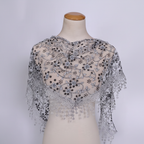 Womens grey triangle lace scarf displayed on a clean neutral studio background showing full lace detail and triangular silhouette