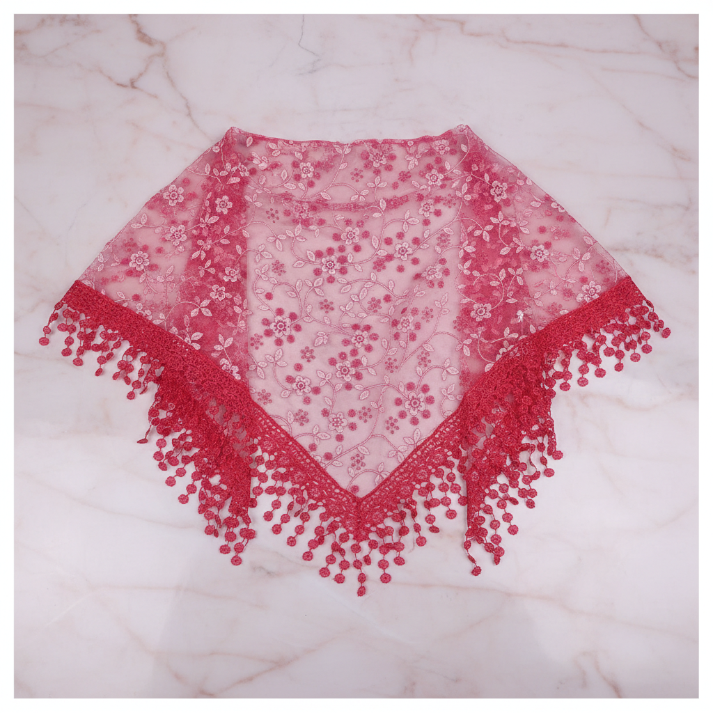Womens rose red triangle lace scarf displayed flat on a blush marble surface, showing delicate lace detail and vibrant colour