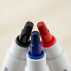 Extreme macro close-up of Swift whiteboard marker round tips in black, blue and red showing precision tip quality and craftsmanship