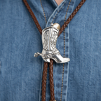 Extreme macro close-up of cowboy boot bolo tie silver boot charm and cord tip detail