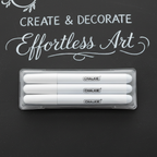 Pack of 4 white liquid chalk marker pens on a dark chalkboard background with chalk lettering