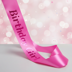 Pink Birthday Girl Satin Sash product shot on soft pink background — vibrant satin fabric with bold lettering