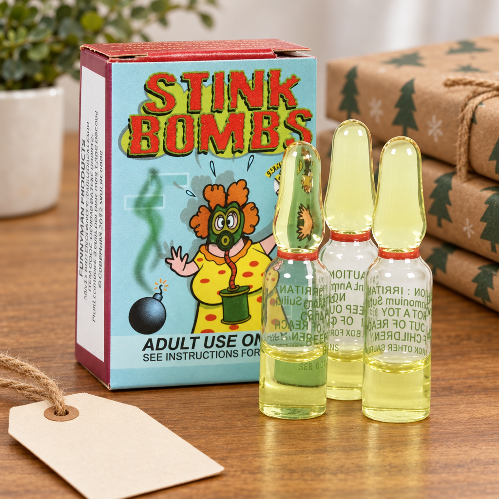 Stink Bombs box and three ampoules on a wooden table beside a gift tag and wrapped gifts