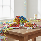 HTI Boom Bomb Bags arranged on a wooden party table with colourful streamers and confetti in natural window light