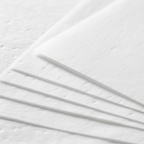 Extreme macro close-up of white tissue paper texture showing delicate fibres and soft translucent quality