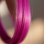 Extreme macro close-up of fuchsia Stargazer hair extension fibres showing silky texture and vibrant colour quality