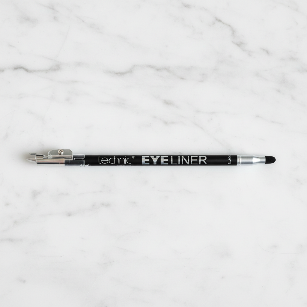 Technic Black Eyeliner Pencil with smudger and sharpener on white marble surface - professional product photography