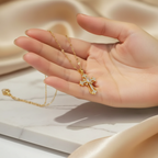 Close-up of elegant gold cross pendant necklace held delicately - premium jewelry detail and quality showcase