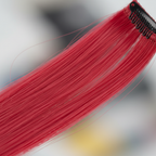 Extreme macro close-up of Stargazer cherry red hair extension fibres showing silky smooth texture and vibrant colour