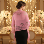 Woman wearing pink lace pashmina shawl at an elegant wedding reception