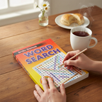 Brain Games Word Search Book open on kitchen table with a cup of tea