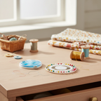 Sewing Box pins and needles set in a cosy home craft room setting with thread spools and fabric in natural window light
