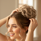 Woman styling her hair with a cool ash blonde curly messy hair bun clip-in hairpiece shade 112 Ash Moon, candid natural moment with bokeh background