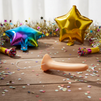 Long Nose Liar Pinocchio prop on rustic wooden surface with party props and confetti