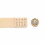 Adorn nude bra extension strap flat lay beside £1 coin on white background showing 3.8cm size scale