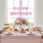 Mother's Day brunch table setting with pink and white celebration banner above