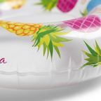 Extreme macro close-up of Intex swim ring vinyl surface showing vibrant pineapple print quality and texture