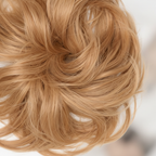 Extreme macro close-up of Flicky wavy scrunchie hairpiece showing individual honey blonde hair strand texture and wave pattern