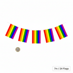 Gay Pride rainbow flag bunting flat lay beside UK £1 coin on white background showing 7m length and 24 flags