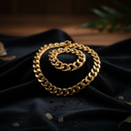 Chunky gold chain necklace 68cm draped over dark velvet surface with moody studio lighting