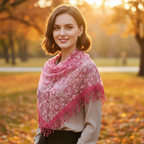 Elegant woman wearing a rose red triangle lace scarf outdoors at golden hour, scarf draped gracefully around her shoulders