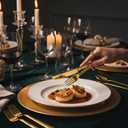 Elegant gold plastic cutlery at a luxury indoor dinner party with candles and wine glasses