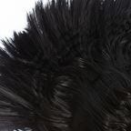 Extreme macro close-up of black mohawk wig spiky hair strands showing texture and synthetic fibre quality