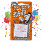 Joke Sneezing Powder packet as the hero product shot against a vibrant colourful party background with confetti and balloons