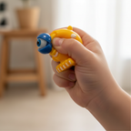 Child squeezing amber yellow Google Eyed Squeeze Monster squishy toy with googly eye popping out